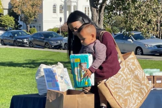 A mom and her son donating diapers