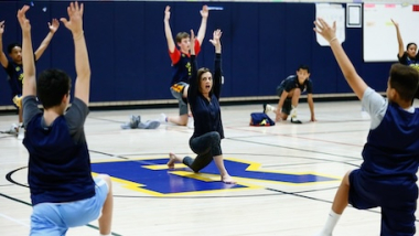 A family doing yoga together at IYK® Family Yoga